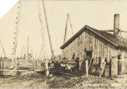 A rig (powerhouse) in Oil Springs powers the jerker line connected to the wells. Date unknown.