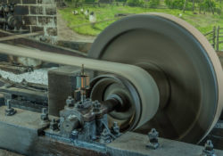 In a rig, the countershaft has babbit, molten metal, around the shaft. The canvas belt, impregnated with rubber, connects to the bullwheel at the opposite end.
