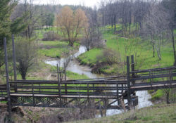 A wooden bridge allows the jerker line to continue on both sides of Black Creek.