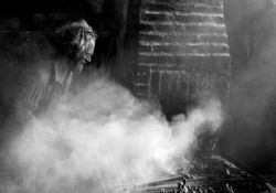 This 1970s photo shows Charlie Fairbank blacksmithing in Oil Springs.