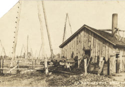 A rig (powerhouse) in Oil Springs powers the jerker line connected to the wells. Date unknown.